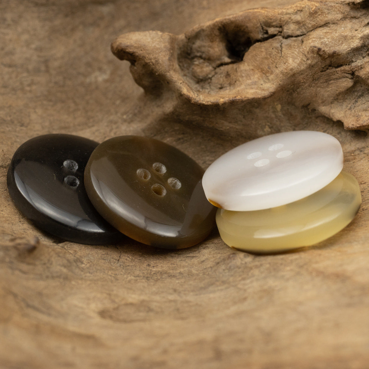 Three round resin buttons with 4 holes: dark brown, muted brown, and creamy ivory