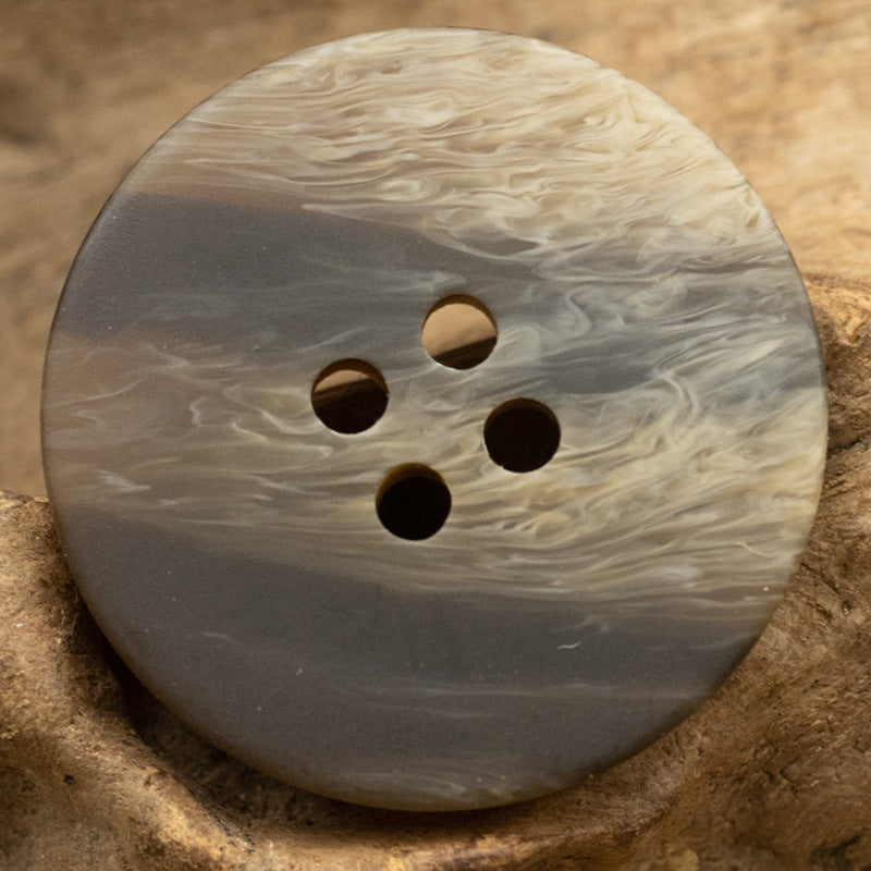 Round resin button, light gray with wood-grain marbling and 4 holes