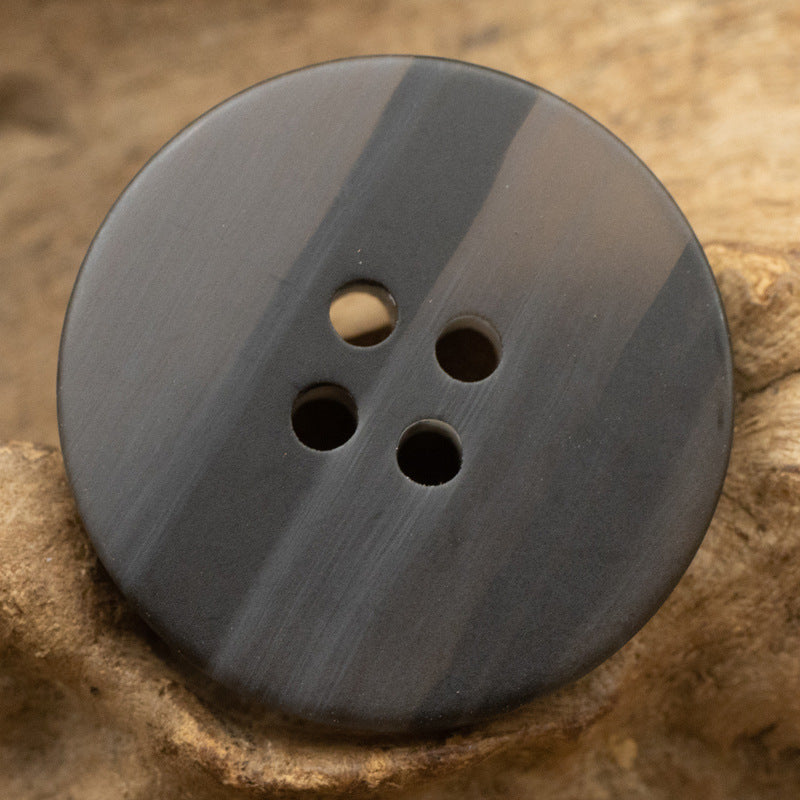 Round resin button, dark gray with 4 holes, wood-grain swirl pattern