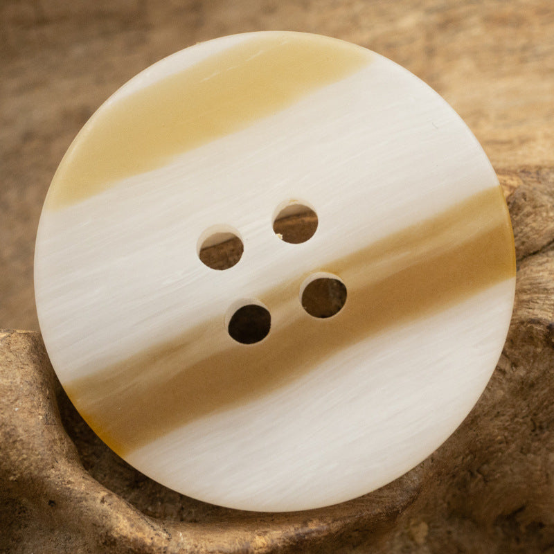 Round resin button, ivory with amber band, 4-hole wood-grain finish