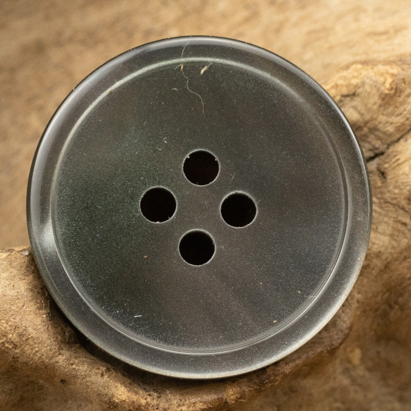 Gray resin 4-hole button with four dark holes