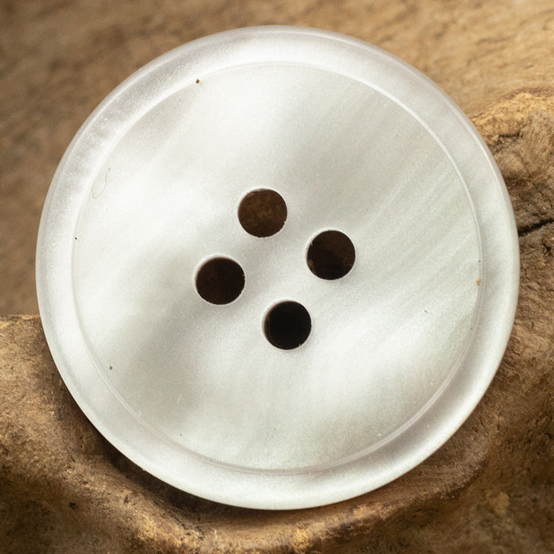 White resin 4-hole button with four dark holes