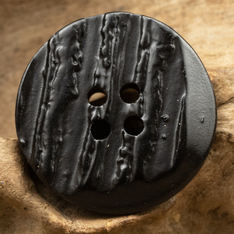 Black charcoal resin button, irregular round with faux tree-bark texture and 4 holes
