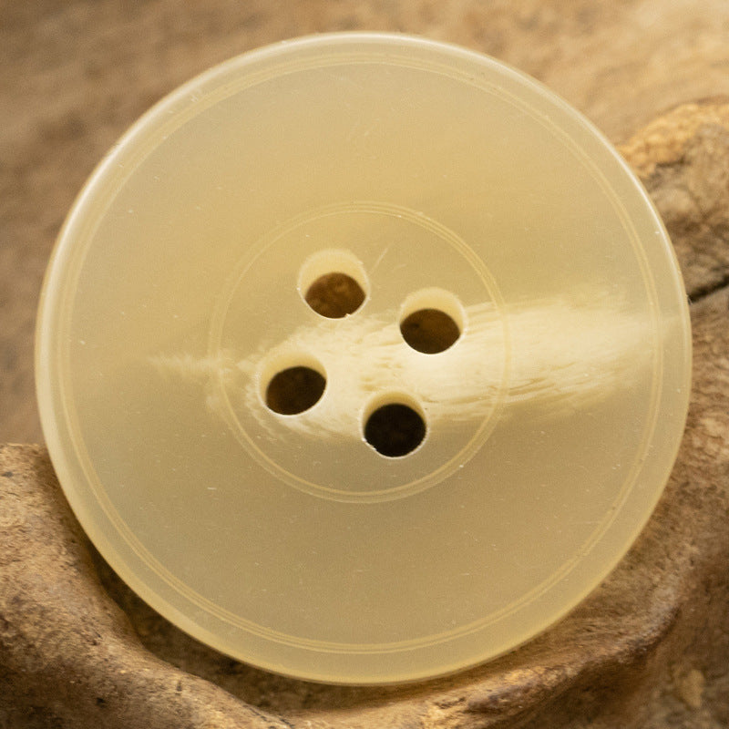 Yellow imitation resin button, 4-hole design with textured finish