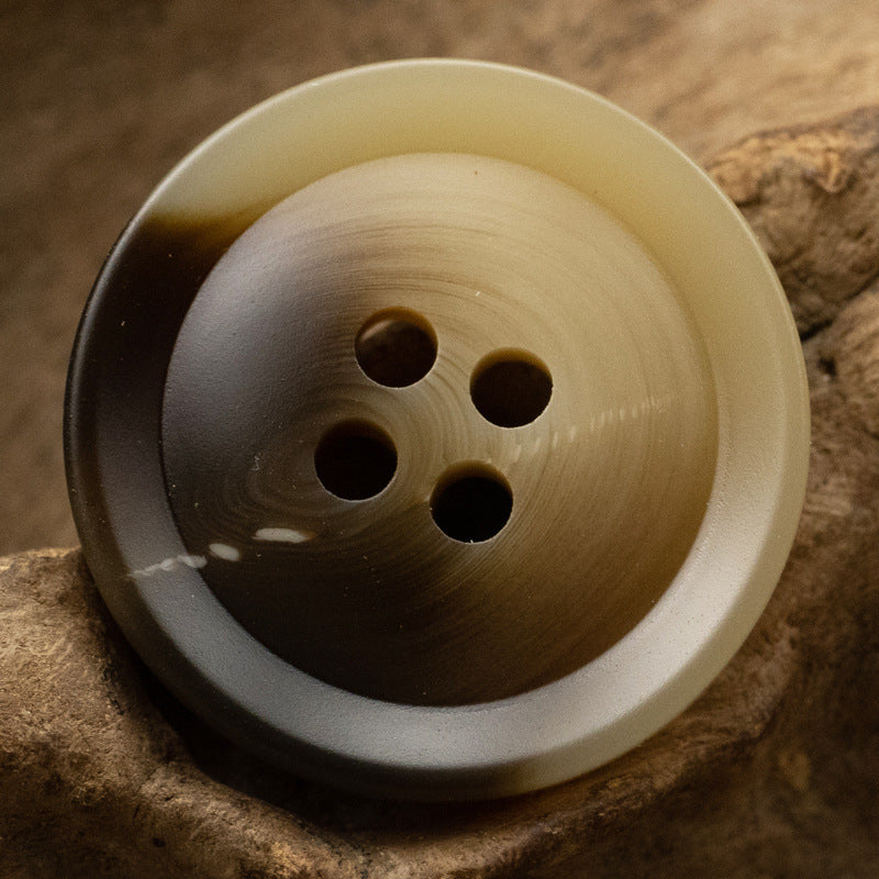 Brown resin suit button, 4-hole, flat back, 15–30mm.