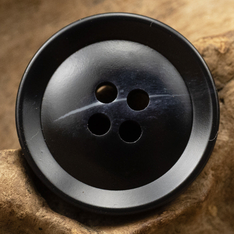 Black resin suit button, 4-hole, flat back, 15–30mm.