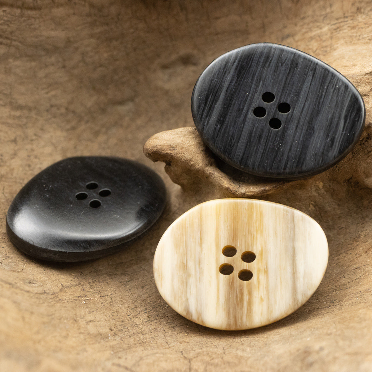 Large oval resin buttons in dark and light, wood-grain finish, each with 4 holes