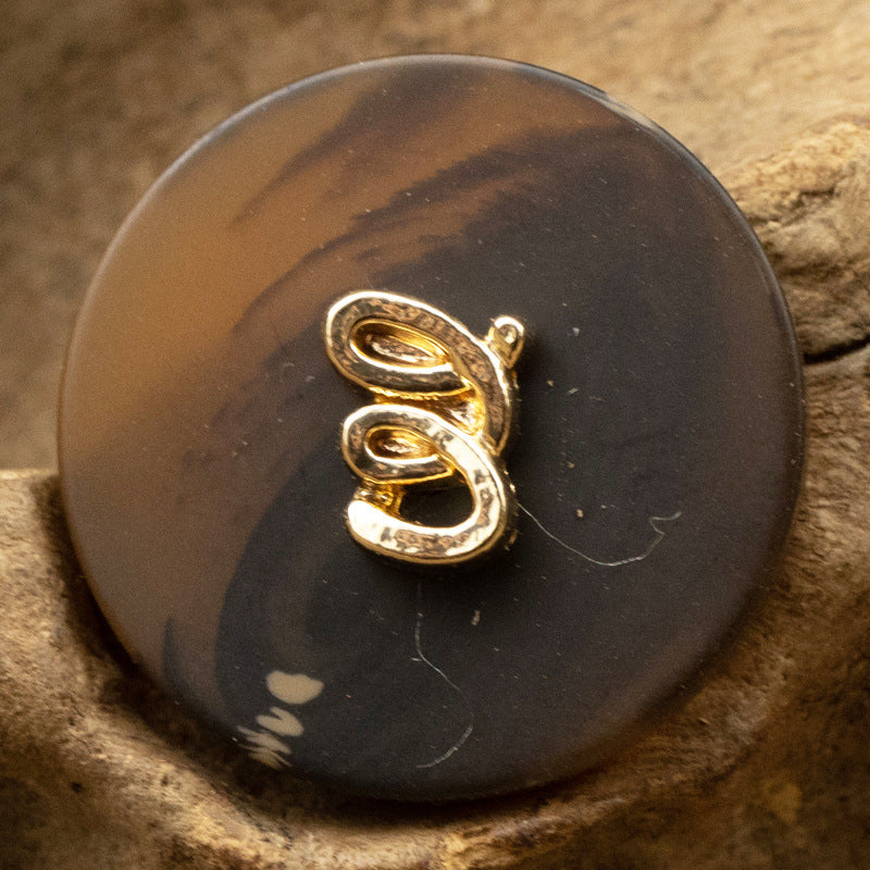 Dark coffee-brown resin blazer button with gold-tone metal shank and 2-hole loop detail