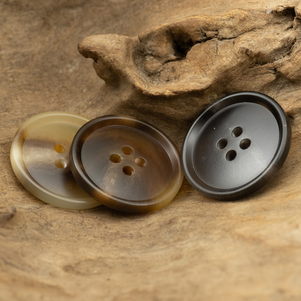 Resin suit buttons with 4 holes: light amber, dark brown, and gray-black