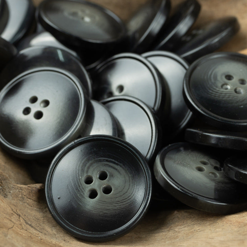 Resin buttons with 4 holes in dark gray and black tones for trousers