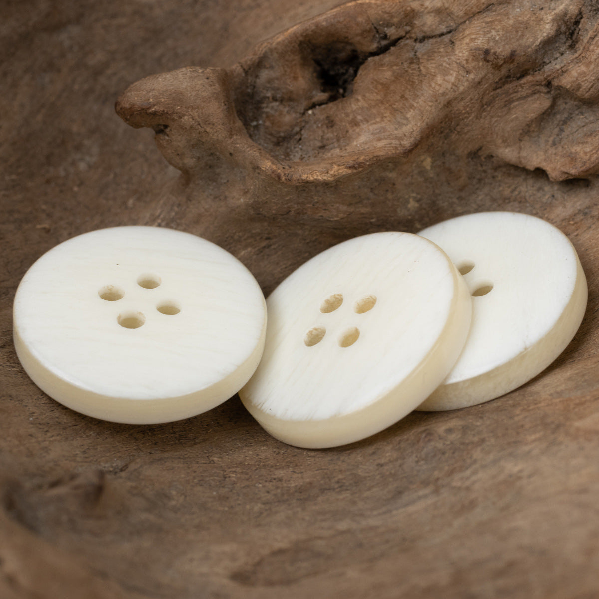Light beige woodgrain resin buttons, 4-hole, side-by-side view
