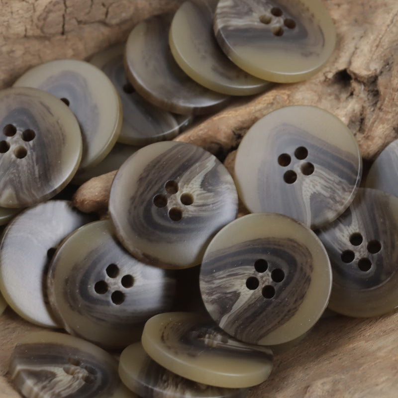 Resin buttons in khaki-brown tones with V-shaped beach pattern and four holes
