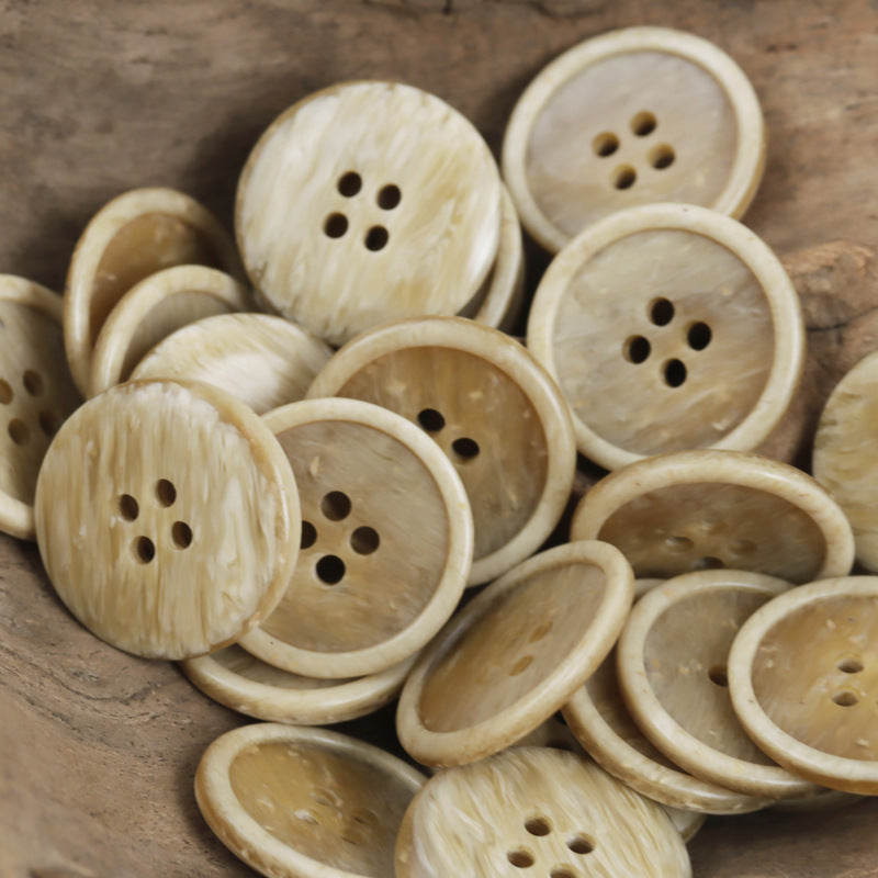 Four-hole resin buttons, tan wood-chip texture, round face with four holes