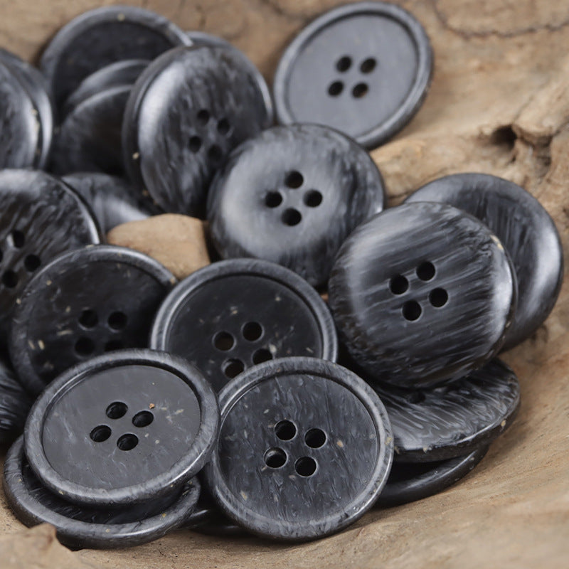 Four-hole resin buttons, dark charcoal wood-chip texture, round with 4 holes