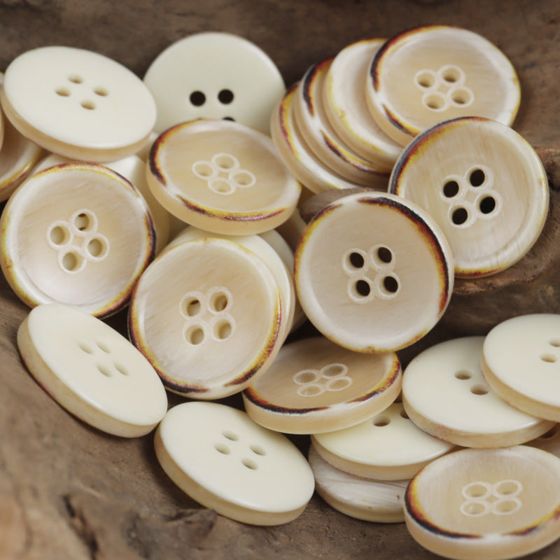 Ivory 4-hole round resin buttons with vintage rim and flower-shaped holes