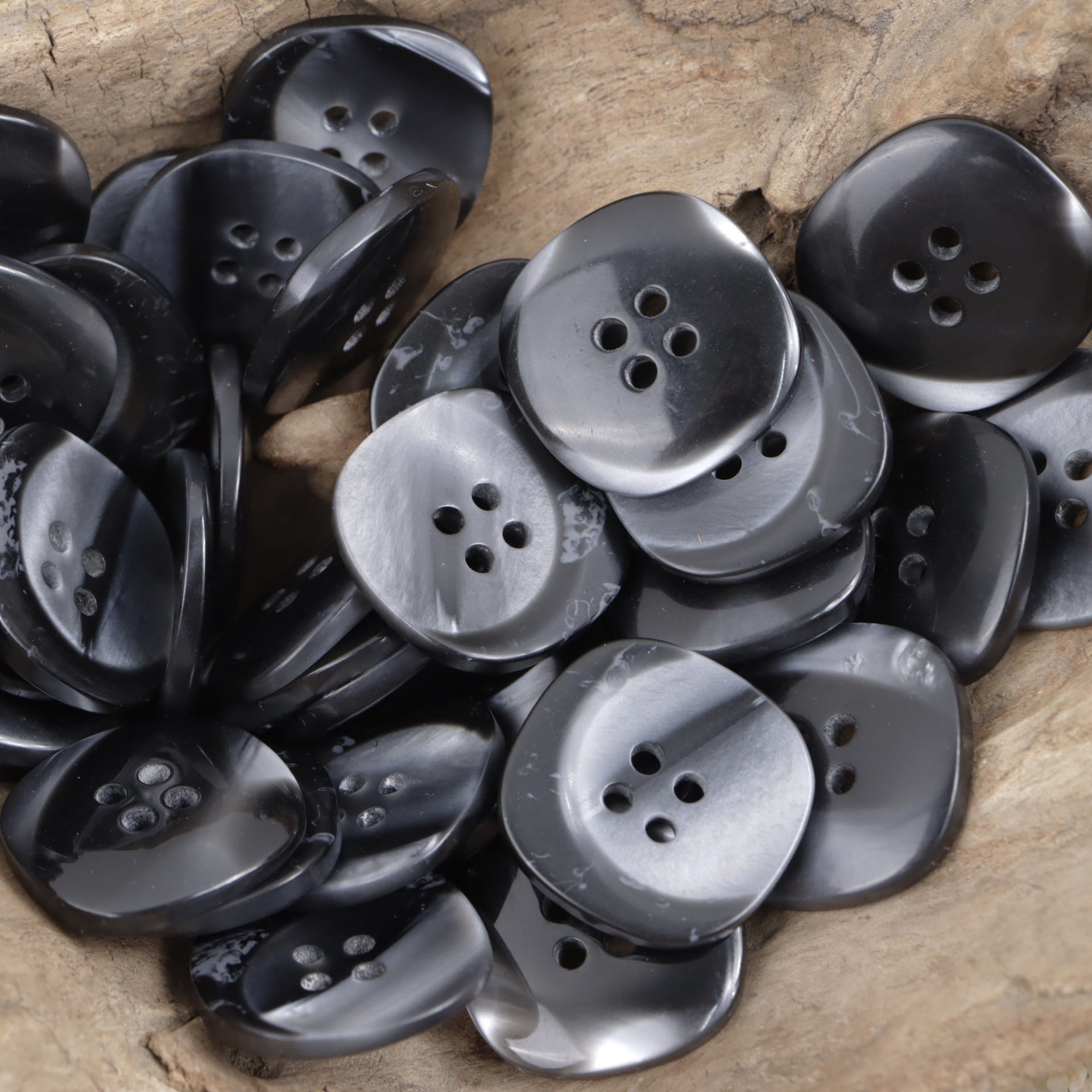 Black resin buttons, matte finish, round with 4 holes