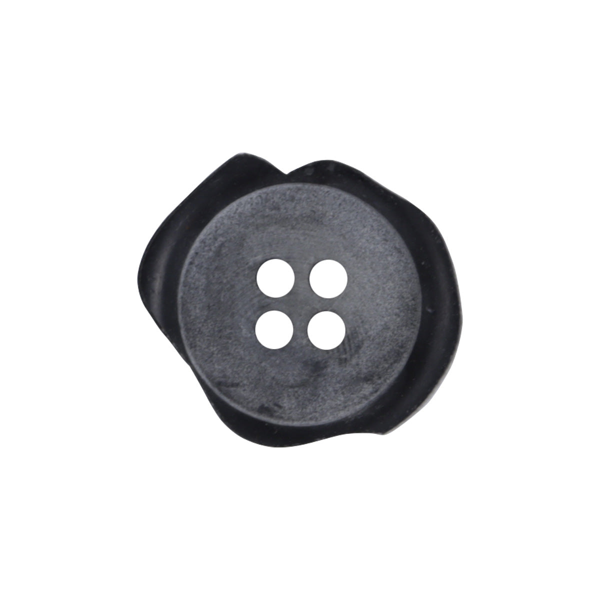 Irregular matte black resin button, four holes; chipped edge, close-up front.
