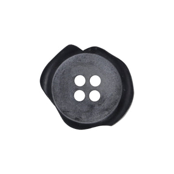 Irregular matte black resin button, four holes; chipped edge, close-up front.