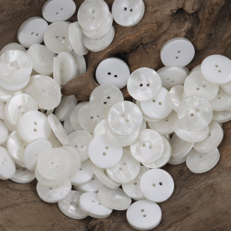 White round resin buttons with two holes, flat sewing button fronts