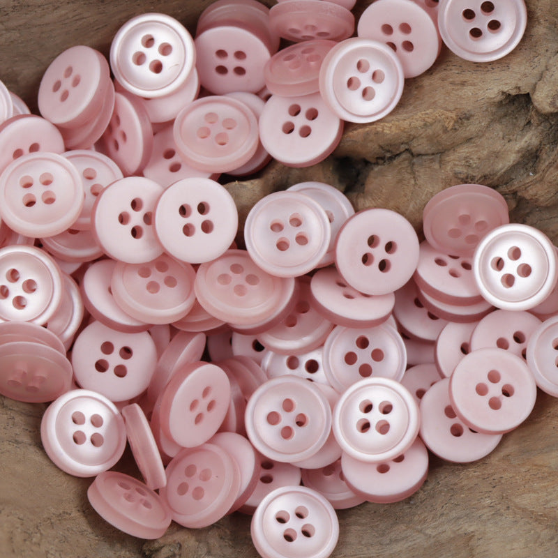 Light pink 4-hole resin buttons, 11.5mm, shown close together
