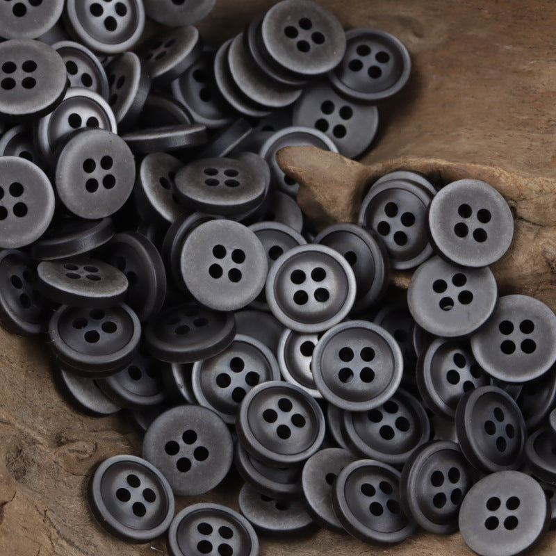 Dark gray 4-hole resin buttons with lighter edges, 11.5mm, in a dense pile