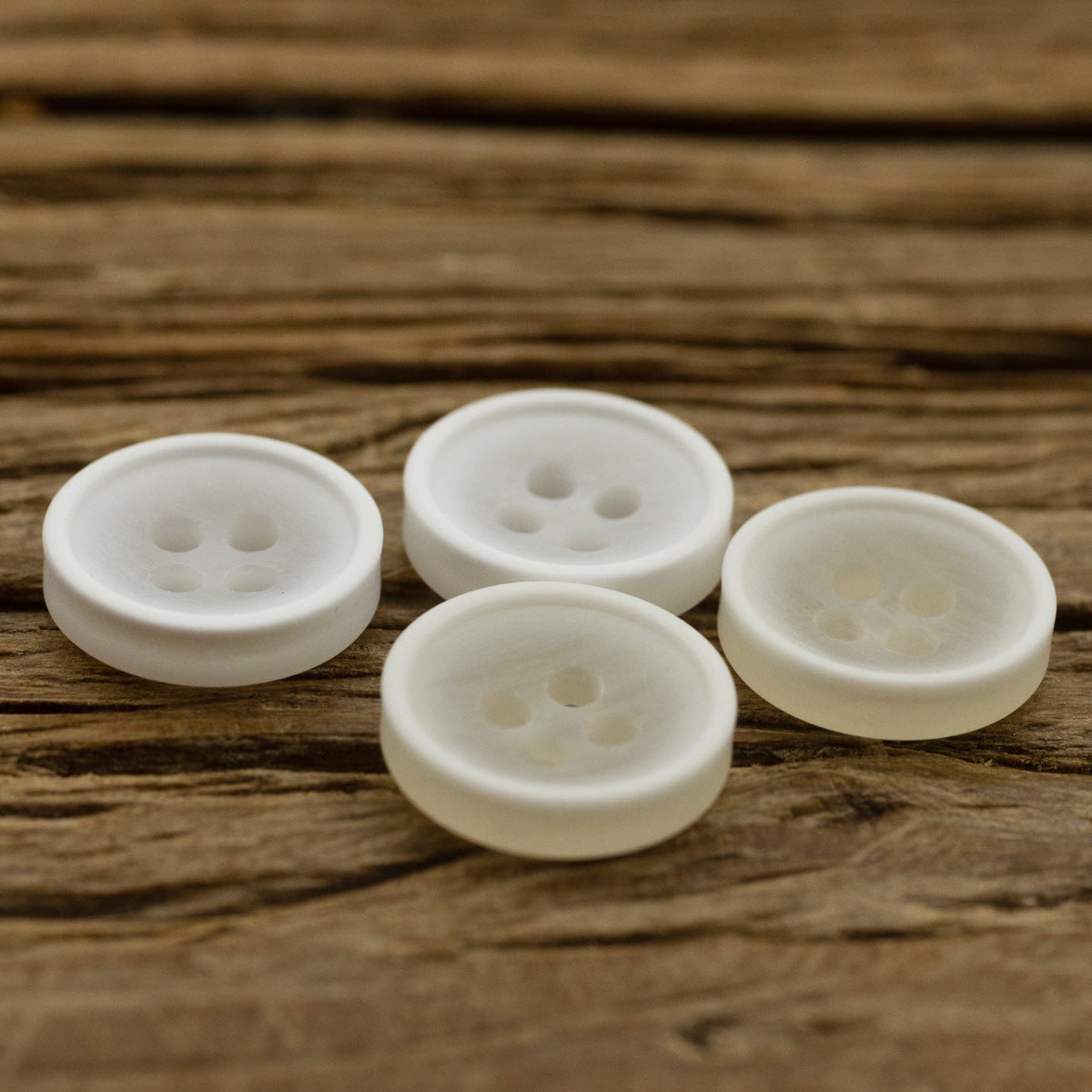 11.5mm translucent resin shirt buttons, 4-hole, white, multiple front views