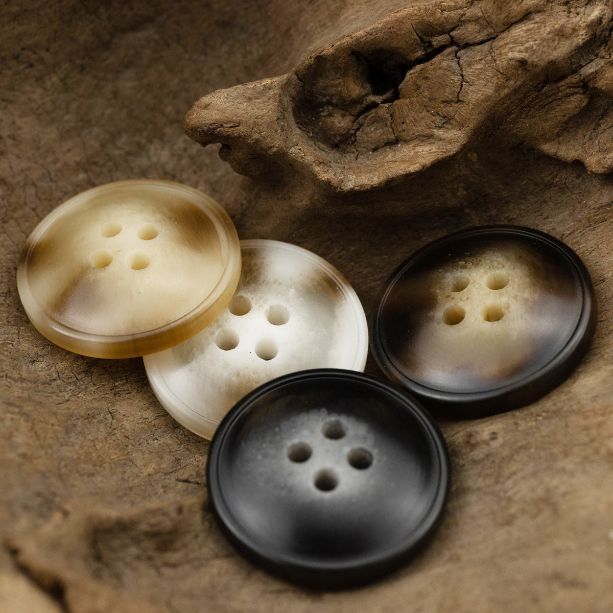 Resin buttons set on surface: off-white, light, and dark tones, 4-hole designs