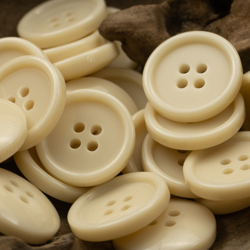 Round four-hole resin buttons in light cream color