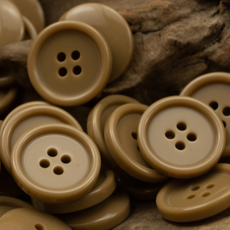 Round four-hole resin buttons in tan and caramel brown tones
