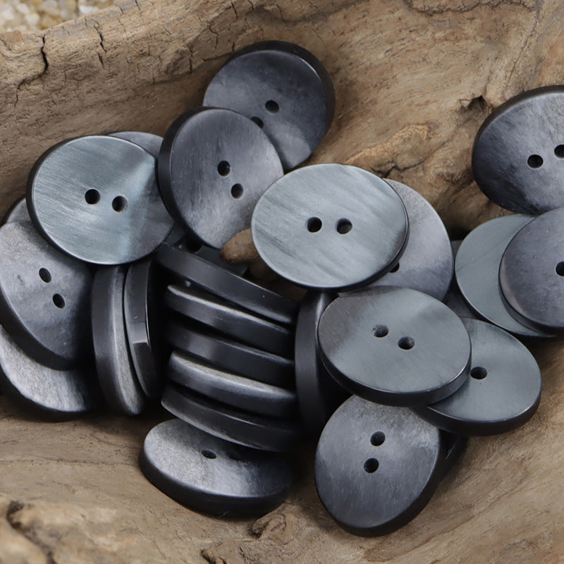 Oval 2-hole resin buttons in dark gray, matte speckled finish