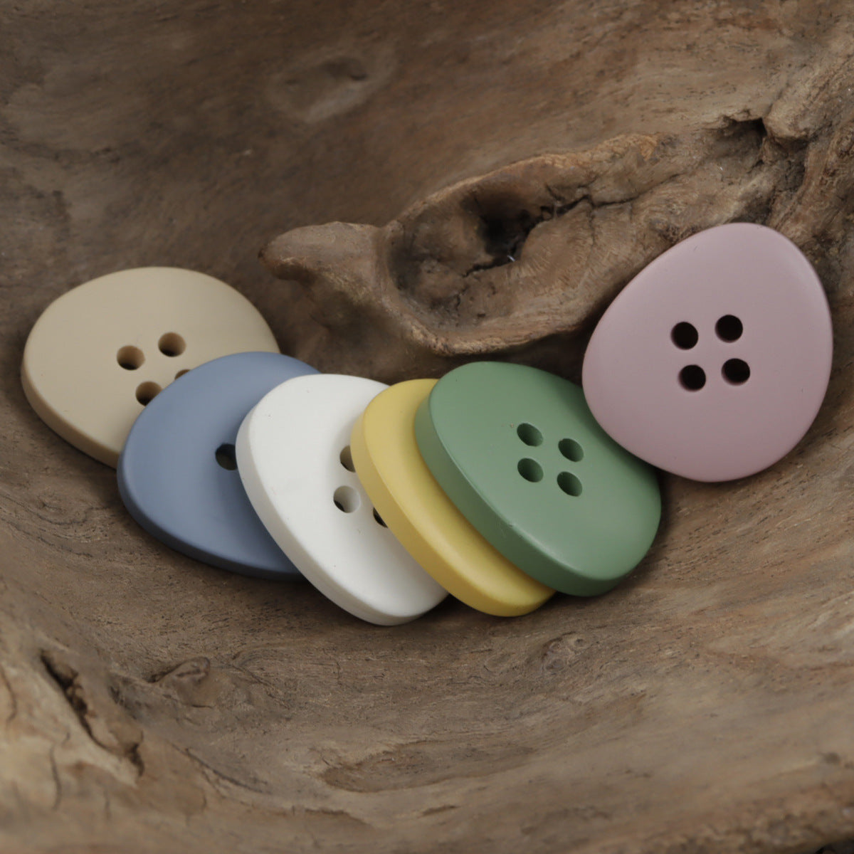 Irregular 4-hole resin buttons in pastel mix: white, yellow, green, blue, lilac, pink