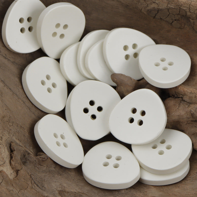 Irregular 4-hole resin buttons, white set with four holes