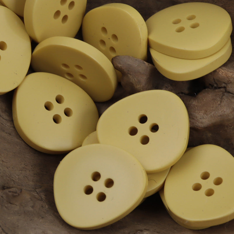 Irregular 4-hole resin buttons, soft yellow set with four holes