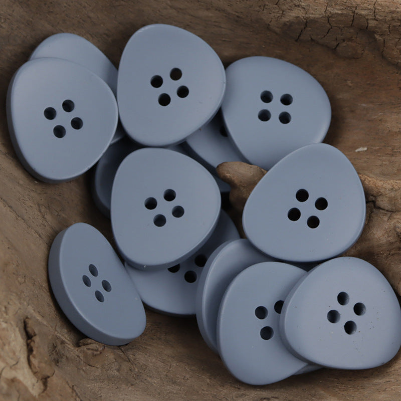 Irregular 4-hole resin buttons, light blue set with four holes