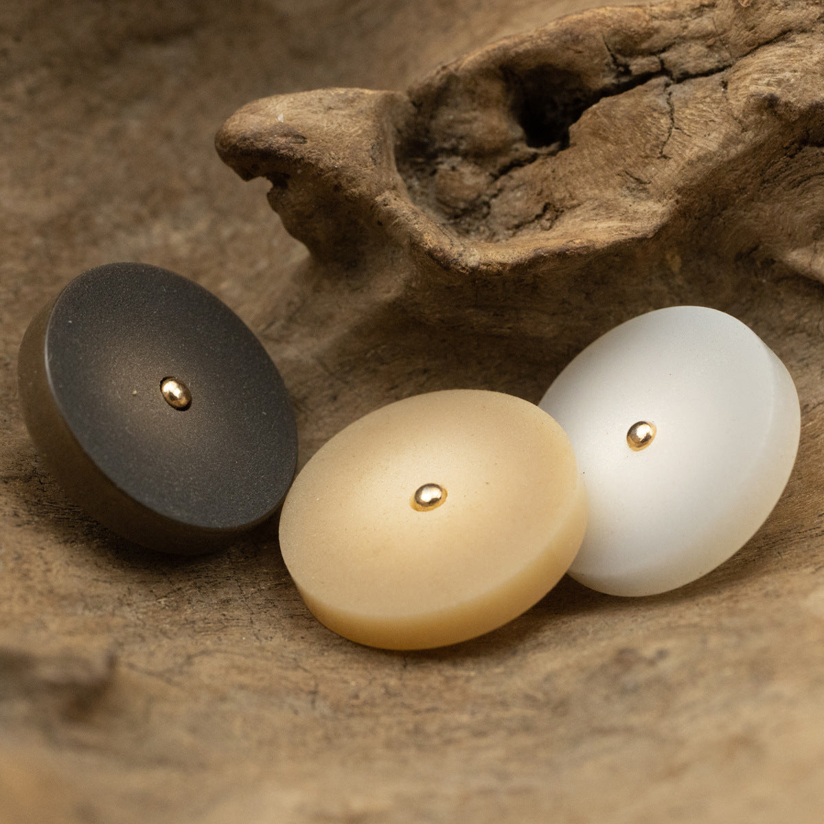 Round frosted resin buttons with metal shanks in dark, cream, and white tones