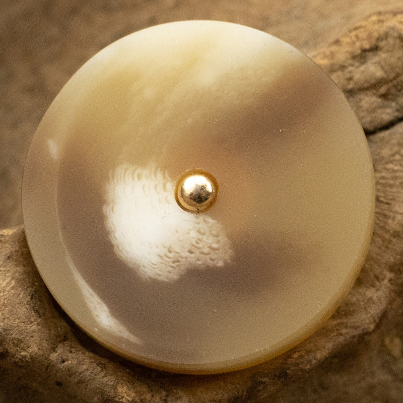 Resin button, tan/beige round with gold metal shank and speckled center
