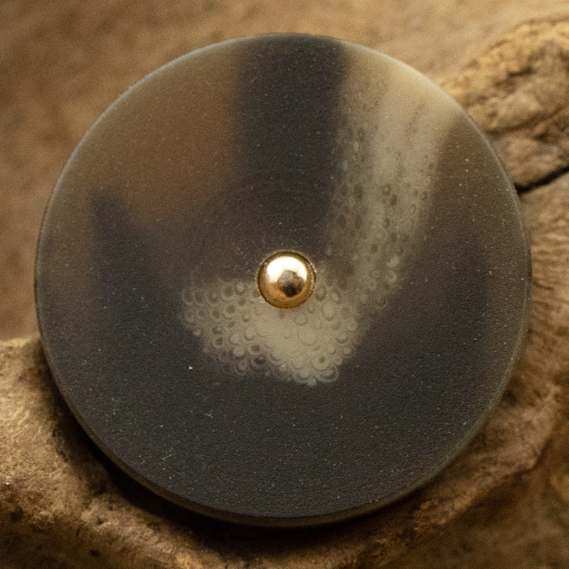 Resin button, dark brown/black round with gold metal shank and pale speckling