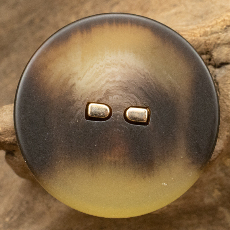 Dark brown flat resin button, round, two-hole metal stems, amber glow