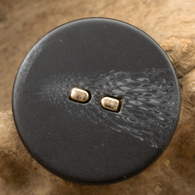 Black flat resin button with metal stems, round, two-hole design, mottled sheen