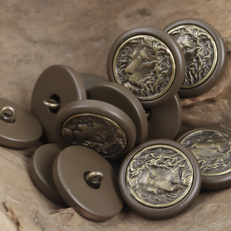 Round resin buttons in brown tones, bronze lion face medallion with raised border