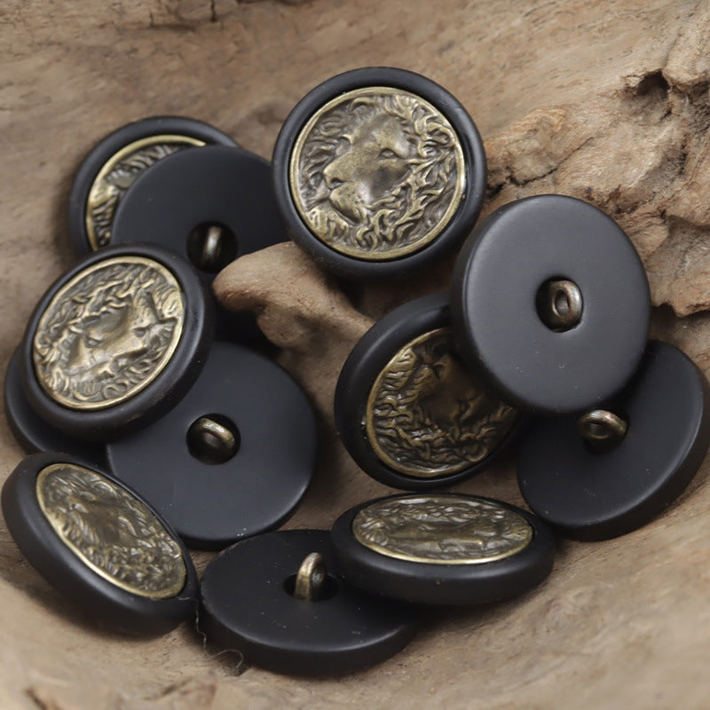 Round resin buttons in black/dark gray with bronze lion medallion center