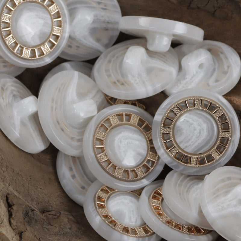 White resin button with antique gold-tone chessboard rim and ornate border