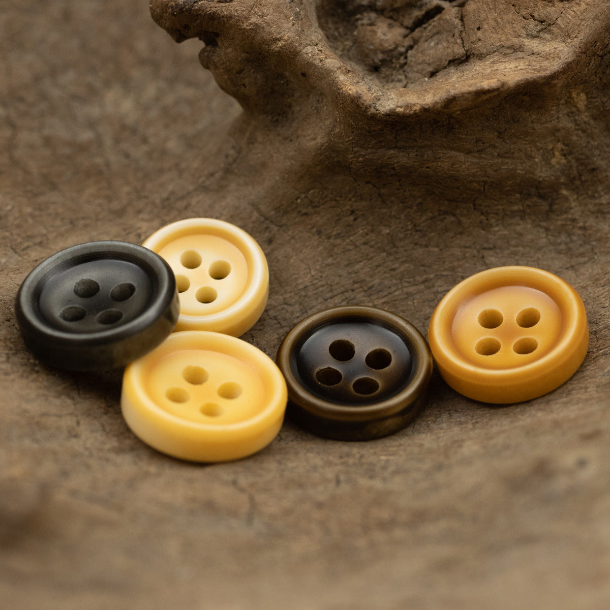 Orange and dark resin shirt buttons, each with four holes