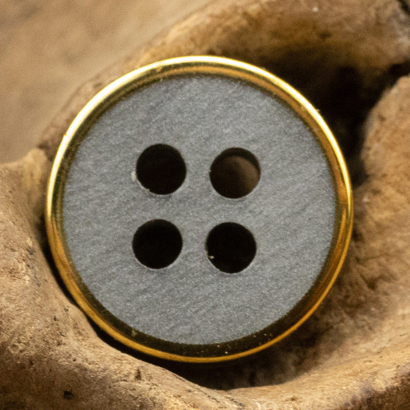 Gray wood-grain resin button with gold rim, four-hole face