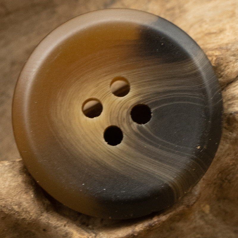 Brown resin button with four holes and striped woodgrain, 15–30 mm