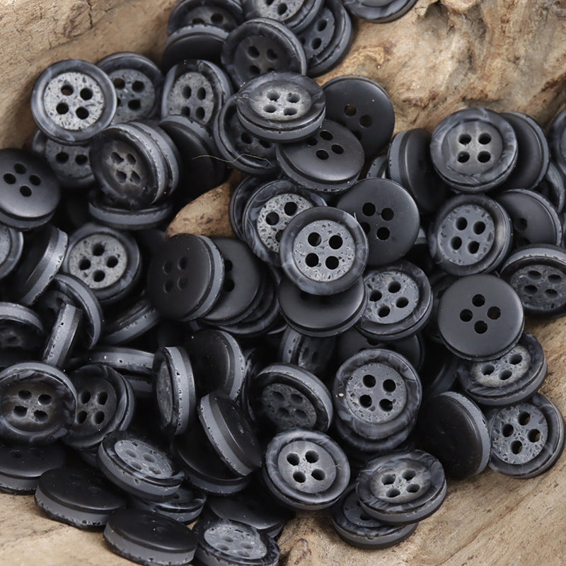 Dark gray resin four-hole buttons with two-tone pebble pattern, mixed pile