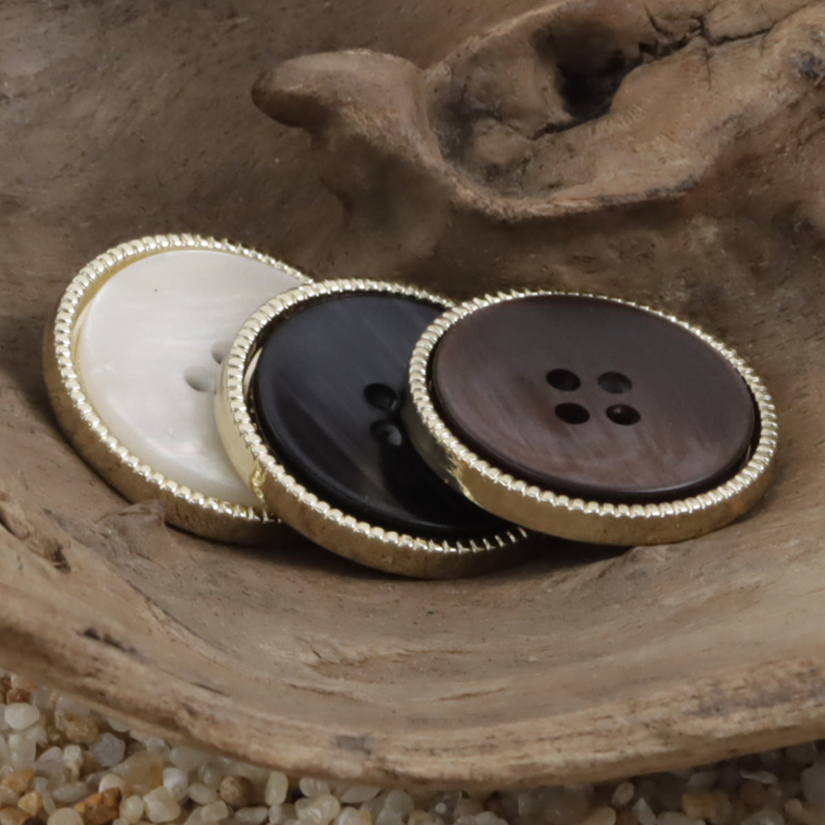 Double-sided two-tone suit buttons with dark resin faces and gold beaded edge