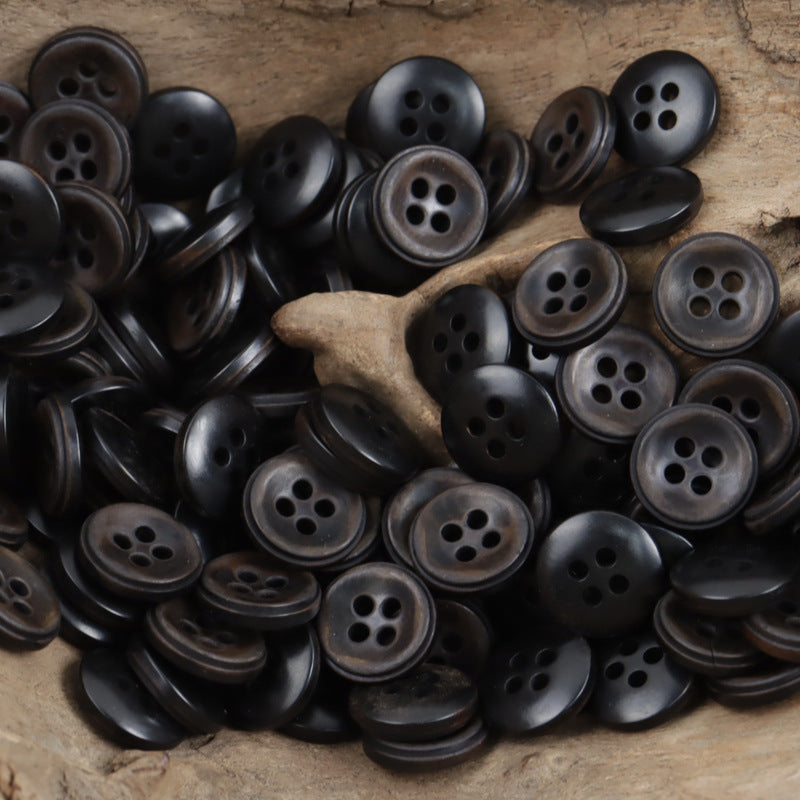 Bulk tray of vintage dark green 4-hole fruit buttons with varied rim colors