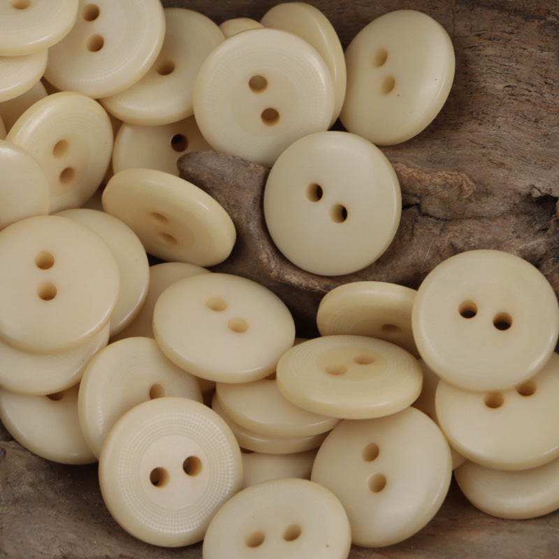 Assorted round 2-hole corozo-style buttons, natural cream yellow