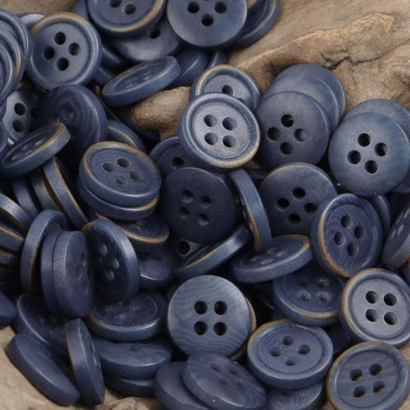 Deep purple natural fruit buttons close-up, round faces with four holes